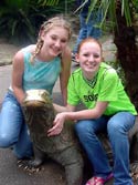 Holly and Lauren posing with a komodo dragon
