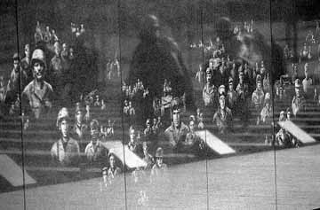 Korean War - The Wall - A mural of more than 2,500 documentary photographs sandblasted into a graphite wall tells the story of the men and women who provided land services and air and sea support for ground troops. The images are taken from military archives. From a distance, the faces of nurses, chaplains, mechanics and other support personnel soften and blend together, providing a backdrop for the statues that echoes the rolling hills of Korea. The images are not identified by name, rank or serial number, but are grouped by service: Army on the left, Air Force in the middle, and Navy/Marines on the right. Visitors may make rubbings of the images.