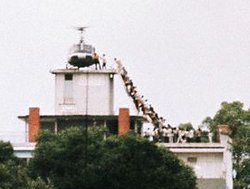 VietnamWar - South Vietnamese civilians scramble to board the last US helicopter leaving the country