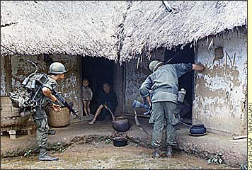 Vietnam War - Combat Chronicles, Photographs of the Vietnam War Part 1 - Searching villages, Troops of the 1st Air Cavalry Division check houses while patrolling an area 25 miles (40 km) north of Qui Nhon as part of Operation Thayer, October 1966. The mission was designed to clear out a mountain range where two battalions of North Vietnamese were believed to be preparing for an attack on an airstrip.